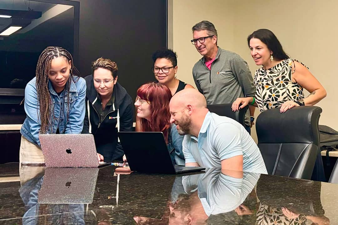 Members of Circuit Breaker Labs and mpathic teams reviewing reports together.